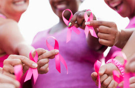 women holding breast cancer ribbons